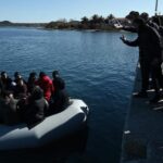 migrants_are_seen_on_an_inflatable_boat_as_local_residents_prevent_them_from_disembarking_in_lesbos_island_on_march_1_2020._afp