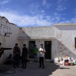 Migrants, most of them from Afghanistan, gather at an old school used as a temporary shelter on the island of Kythira, southern Greece, Thursday Oct 6, 2022