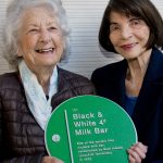 Mick Adams’ daughters holding the Black & White Milk Bar plaque. Photo by Effy Alexakis.