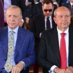 Turkish President Recep Tayyip Erdogan (L) gives glasses to his body guard. Turkish Cypriot leader Ersin Tatar (R). Photo: AP News.