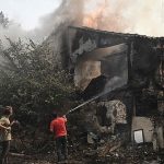 Local-residents-extinguish-a-fire-in-Avanta-near-Alexandroupoli-northern-Greece-on-Tuesday-as-a-wildfire-incinerated-their-homes