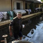 A man walks in his flooded village of Palamas near the city of Karditsa, central Greece.