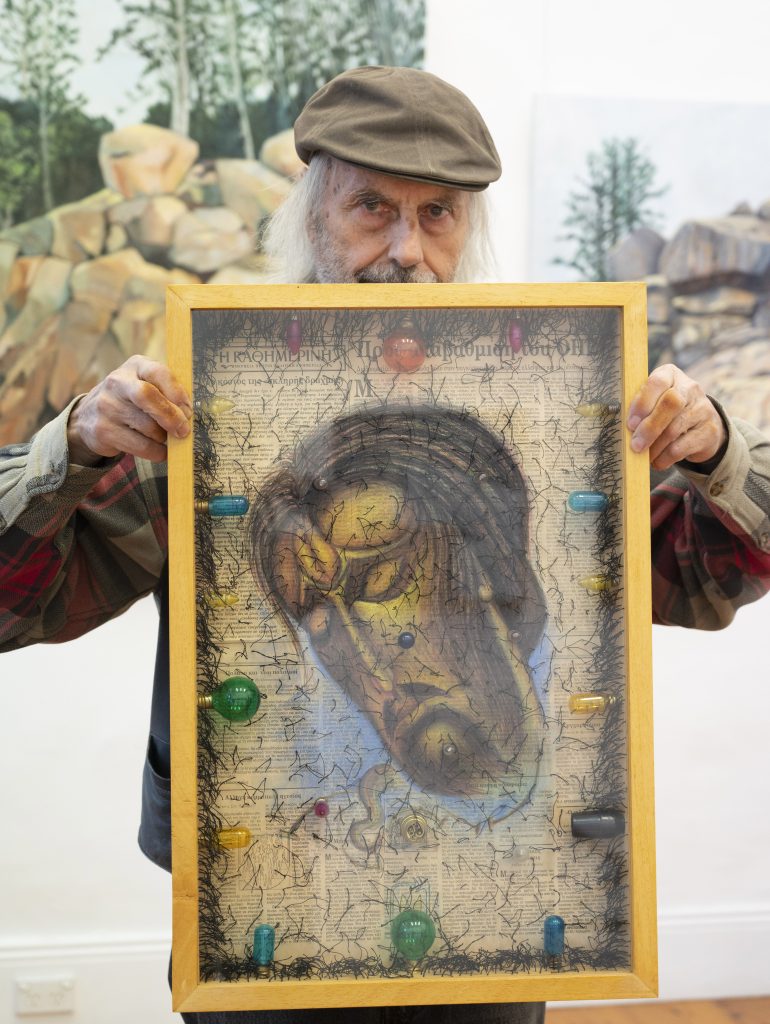 George-Michelakakis-photo-Effy-Alexakis-holding-one-of-his-works-titled-Ephemeral-scaled.