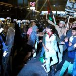 Protesters scuffle with riot police during a rally outside the Israeli Embassy in Athens, Greece.