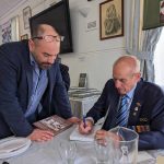 Steve Kyritsis signs copies of his book, available at the Hellenic RSL.