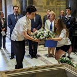 Students lay wreaths within the Shrine