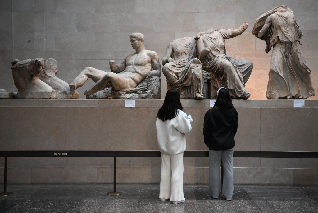 Visitors view the Parthenon Sculptures, also known as the Elgin Marbles, at the British Museum in London. Photo CNN.