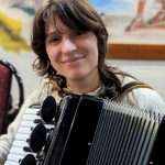 A young accordionist performs for the crowdsl