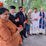 Faith leaders hold candles of hope.