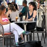 Melanie Lambrou and dog, Paddy, catch up with Isabelle Foscolos in Oakleigh. Photo Joe Armao.