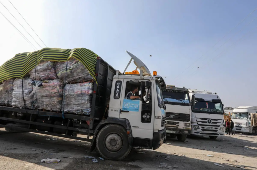 Humanitarian aid trucks sent by UNRWA and Red Crescent pass through Rafah Border Crossing on Egyptian border as they drive to a storage of UNRWA, in Rafah, Gaza on December 18, 2023 [Abed Rahim Khatib – Anadolu Agency]