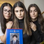 Kristina, Elpida and Georgia Tsindos with a photo of their brother James, who died after suffering an anaphylactic reaction. Photo Wayne Taylor.