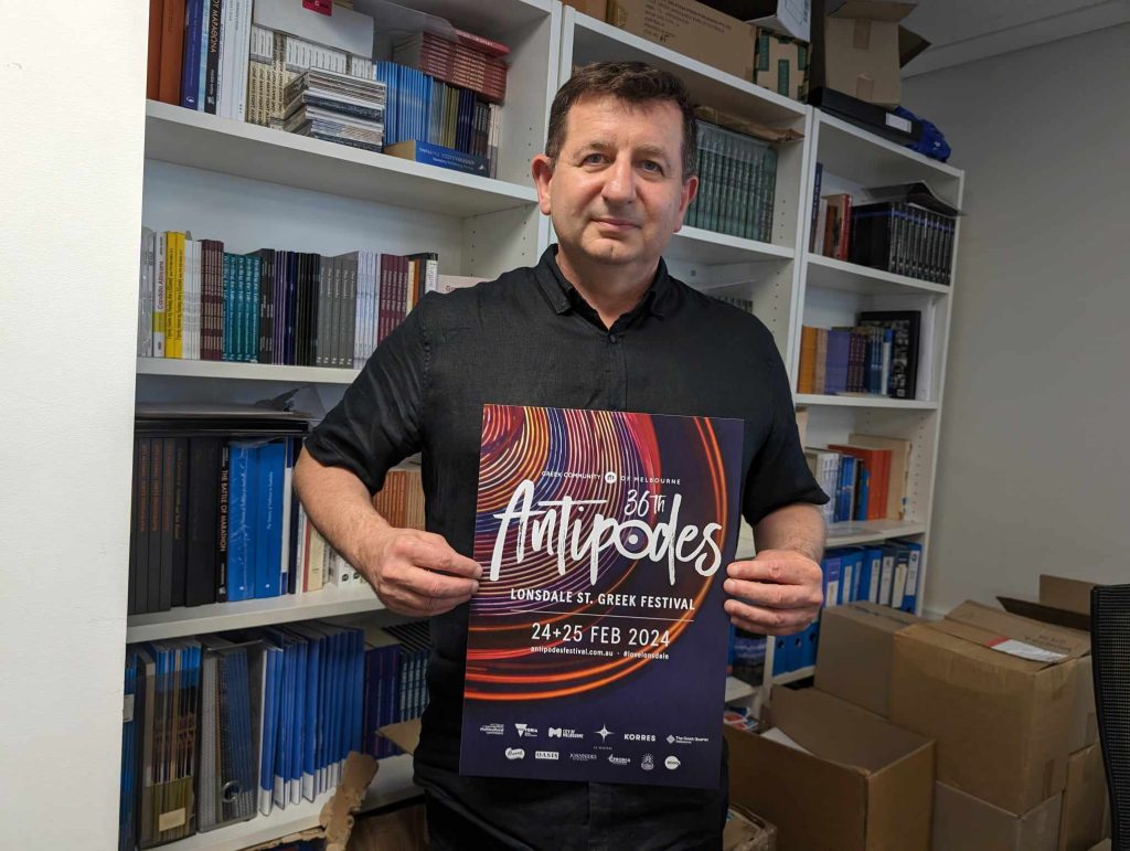 Nick Dallas holds up the poster of the Antipodes Festival. Photo copyright The Greek Herald Mary Sinanidis.