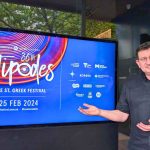 Nick Dallas showcases the sponsors of the Antipodes festival as they flash on the digital sign outside the Greek Centre. Photo copyright The Greek Herald Mary Sinanidis.