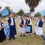 Kids holding Greek flags.
