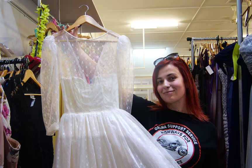 Angela Skordali, with one of the wedding dresses left behind by the previous tenant.(ABC Central West: Micaela Hambrett)