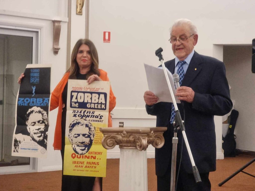 Guest speaker Mr. Peter Yiannoudes and Public relations committee member Emily Kazakos displayed the original posters from 1964 for the movie Zorba the Greek_
