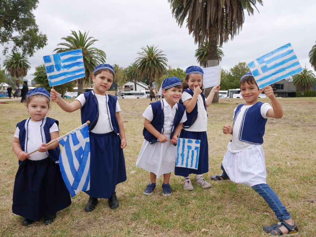 kids waving Greek flags