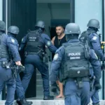 Boulos opens the door to find heavily armed police outside his Picnic Point home. Picture Thomas Lisson.