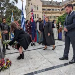 Melbourne University students lay a wreath