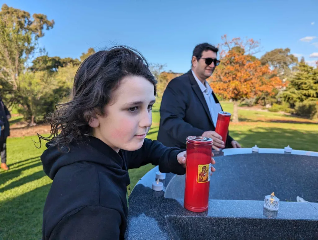 Sebastian Papaioannou, 10, blows out candles at the Monument