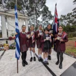 Students from Oakleigh Grammar show the commemorative gift they were given by Simela Stamatopoulos, simply for attending (and chocolates too)