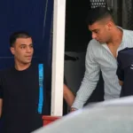 Two of nine Egyptian men accused of causing a shipwreck last year that killed hundreds of migrants arrive at a courthouse for the start of their trial in Kalamata, southwestern Greece, Tuesday, May 21. PThanassis Stavrakis