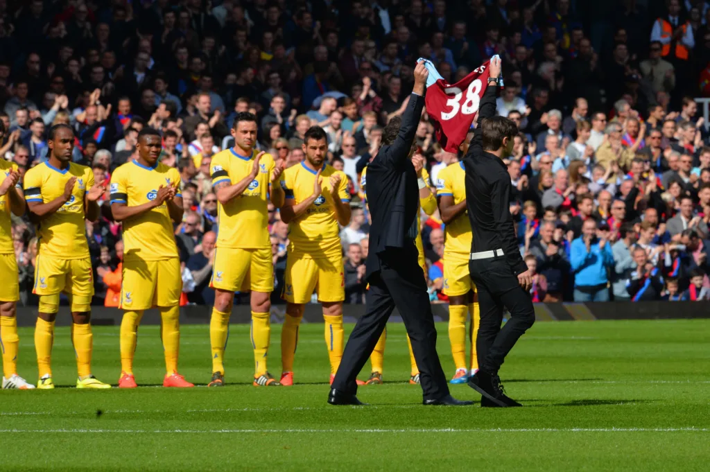 Tombides' jersey is held up before Palace v Hammers in 2015