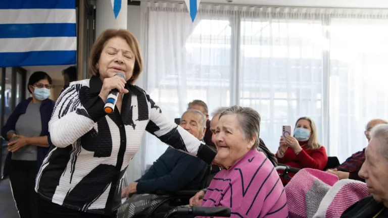 Greek singer Pitsa Papadopoulou surprises elderly residents at St Basils Lakemba