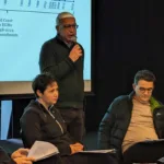 selida_16_GCM Board Member Costas Stefanidis takes the floor. Seated in front of him are Kostas Karamarkos, Vasso Zangalis and Theo Markos.