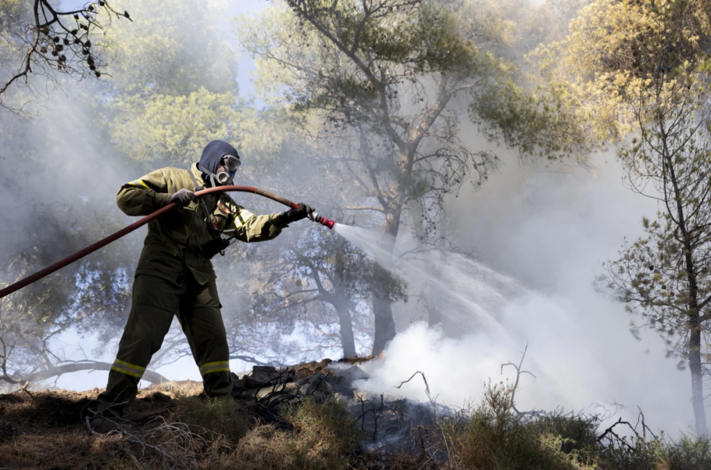 Firefighters battling continuing wildfires in Greece. Photo AP News.