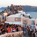 Santorini bursts with tourists as locals call for a cap