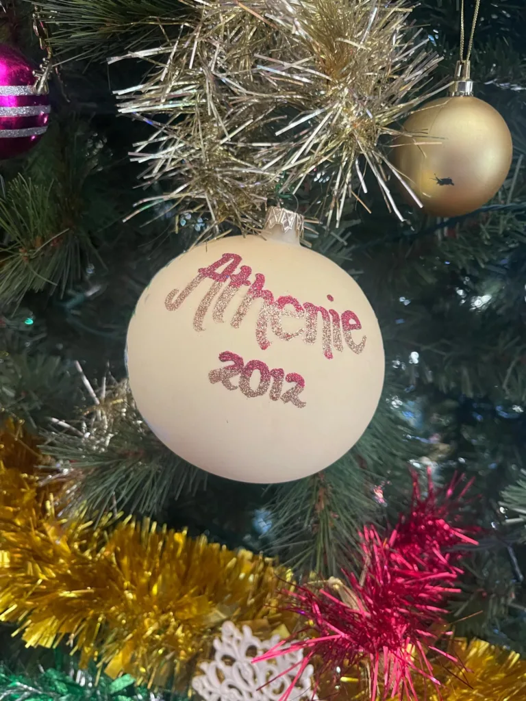 Memories of Athenie, a ball hangs on the Kalos family Christmas tree