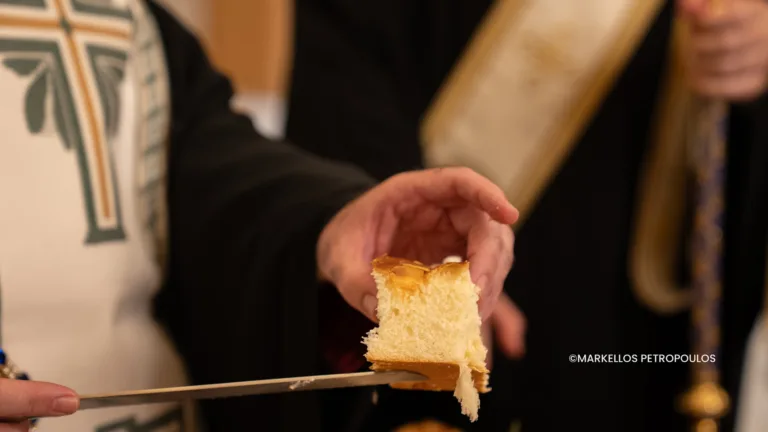 Father Dimitrios Kokkinos finds the coin at Sydney’s annual vasilopita celebration