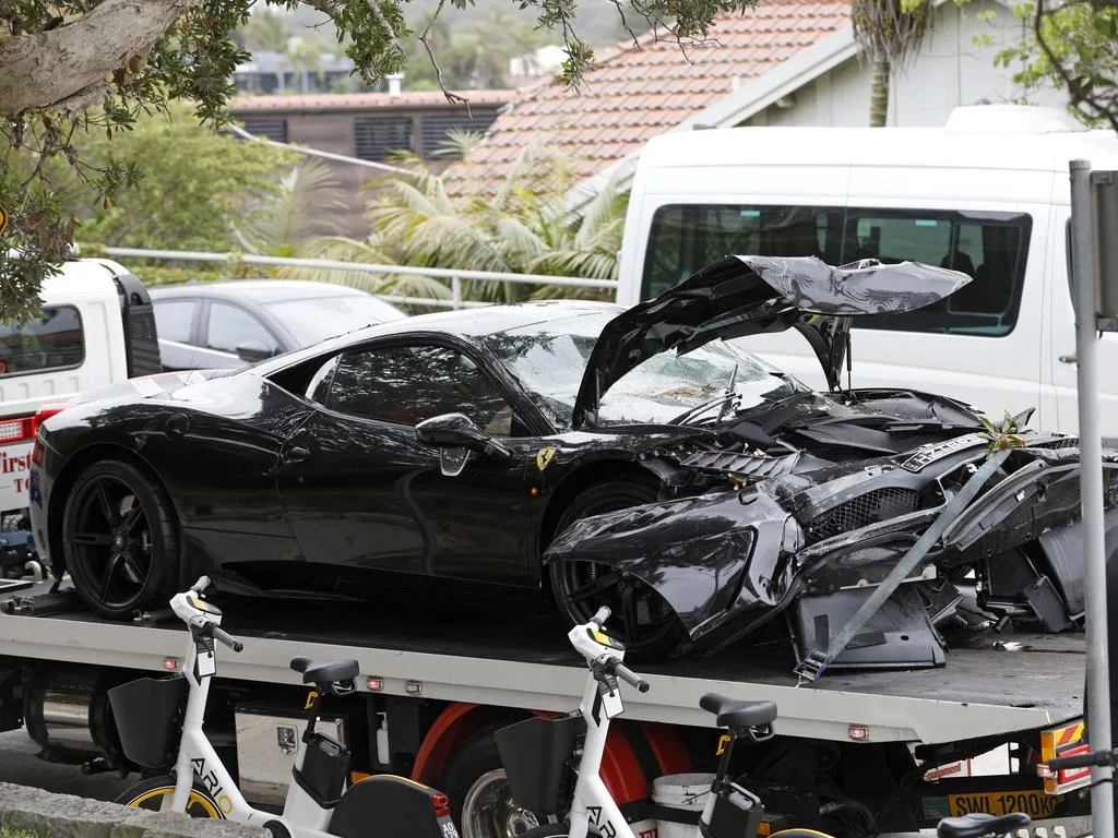 A crashed Ferrari on the back of a tow truck after hitting a wall in Watsons Bay. Picture: Damian Shaw
