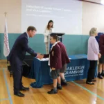 3. Principal Robertson congratulates a student leader