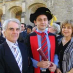 Graduation day with his parents.