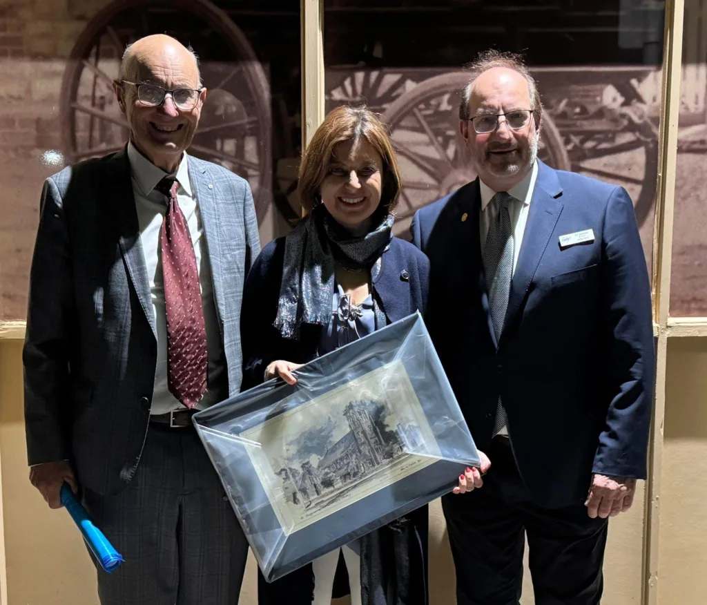 Mayor of the City of Unley, Michael Hewitson and Cr Finos presenting the Consul General with a gift, a painting of the council