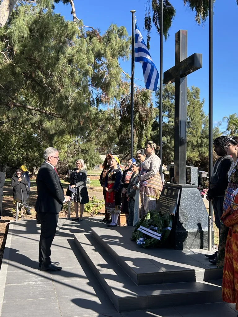 The Hon. Michael Brown MP paying respects and laying a wreath