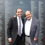 The late Emmanuel Alfieris (left) with his dad George at the National Monument to Migration. Photo: The Greek Herald / Andriana Simos.