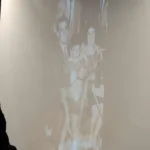 Photos from Peter Jasonides’ life rotated on a screen in the hall
