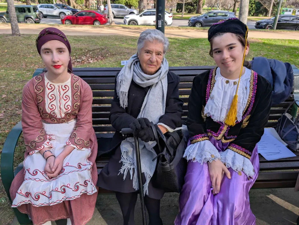 Stavroula Gonopoulou sits with two young dancers from the Pegasus troupe