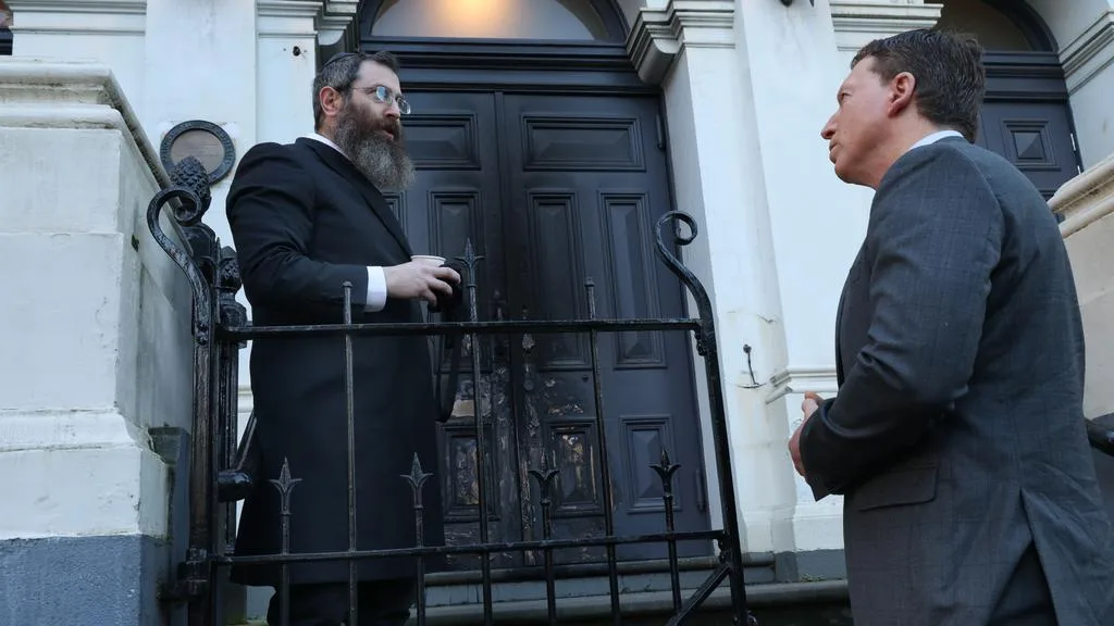 Rabbi Gutnick talks with Dvir Abramovich, the chair of the Anti-Defamation Commission, at the synagogue in East Melbourne where a fire was lit at the doorway on Friday. Picture: David Crosling
