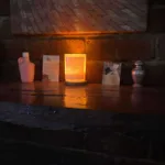 A pink bottle of Holy Water from Tinos beside Sofie’s baby’s urn