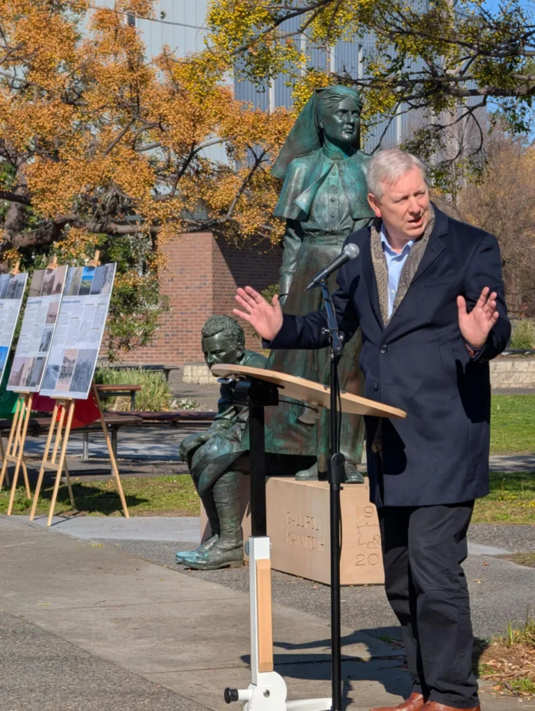 Shadow Minister David Davis points to the monument