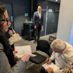 Dimitra-Georgantzoglou-patiently-waits-for-Iakovos-Garivaldis-to-sign-a-copy-of-her-book