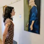 Iris-gazes-at-her-work-titled-Reclaiming-Power