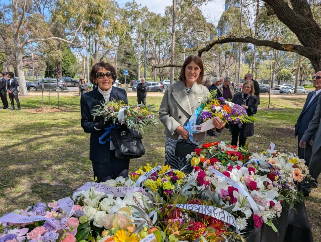 Kaity Georgiou and Nola Radiotis lay their flowers, preparing to lay a wreath.