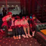 Young boys take a break from the dance to watch a game of soccer