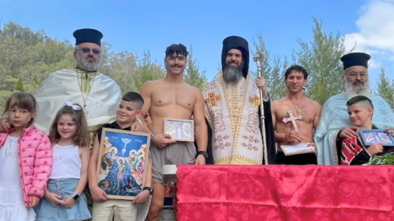 Panos Morogiannis retrieves the Holy Cross at Canberra Epiphany celebrations